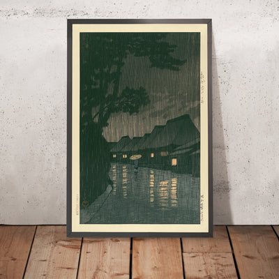 A framed image of Rainy Night in Maekawa by Hasui Kawase, 1935